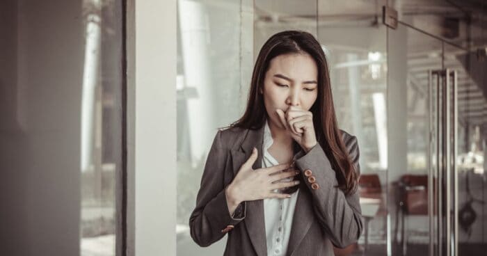 Allergic asthma — Woman experiencing breathlessness, one of the main symptoms of allergic asthma.